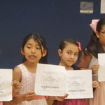 Girls holding completion certificates