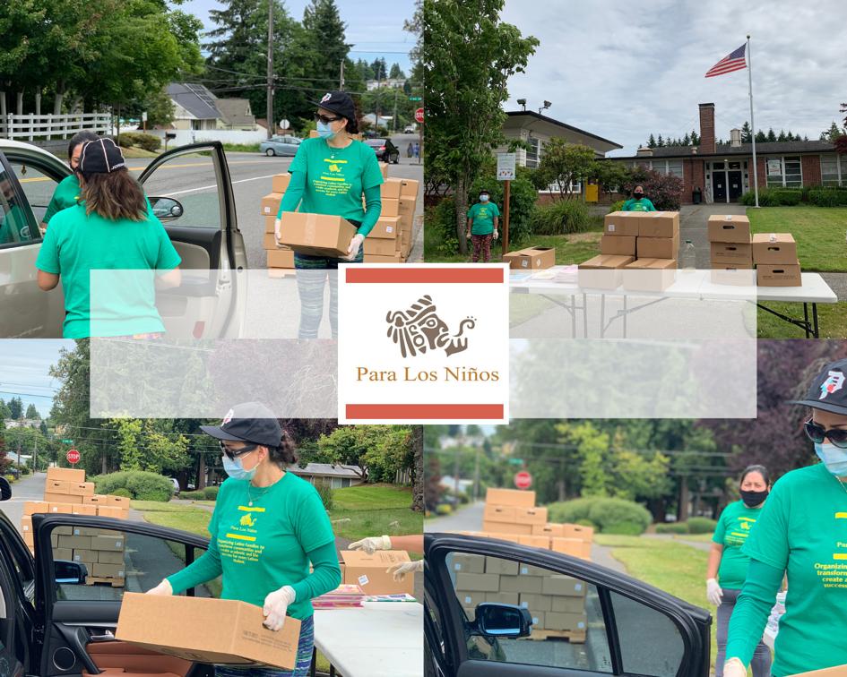 Volunteers from the community carrying boxes of food into cars.
