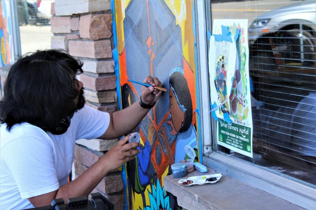 Picture of artist painting mural